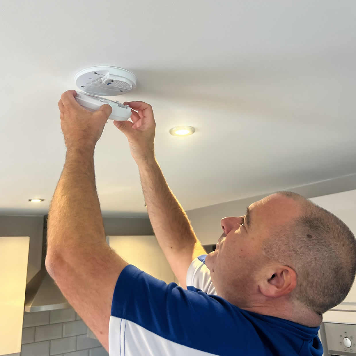 Smoke alarm being installed on a ceiling in Durham